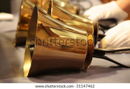 Handbells on table with gloved hands ready to perform Royalty-Free Stock Photo #31147462