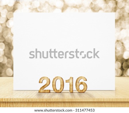 white poster and 2016 year wood texture with sparkling gold bokeh wall and wooden table.
