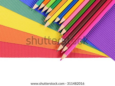 Color pencils on multi-colored paper close up