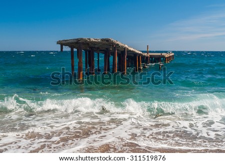 Old ruinous pier on a Black Sea shore in Crimea