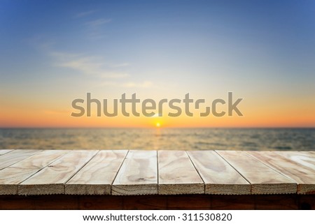 Empty top of wooden table or counter and view of tropical beach. For product display