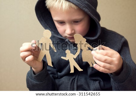 Confused child with broken paper family, family problems, divorce, custody battle, suffer concept 