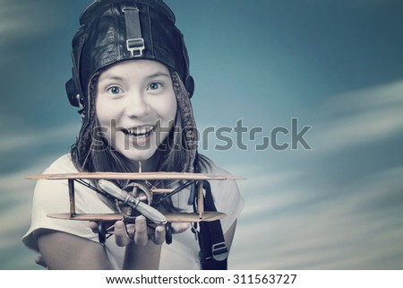 Girl with toy airplane in hand - a symbol of dreams and hopes