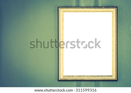 Blank photo frame on wall - vintage filter effect