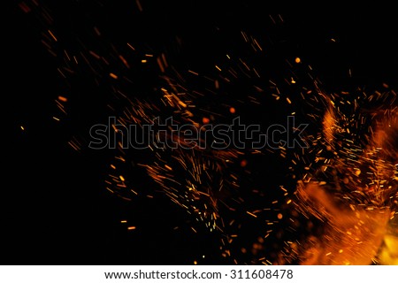 fire flames with sparks on a black background Royalty-Free Stock Photo #311608478