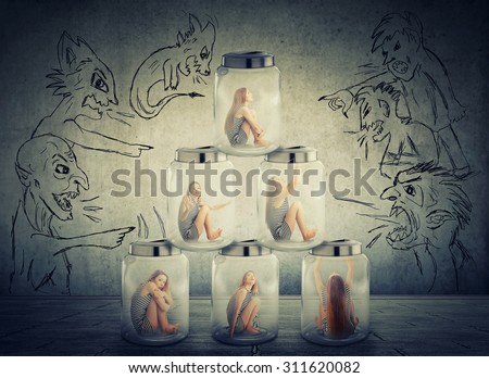 Lack, violation of human rights. Young lonely woman sitting in a pile of glass jars surrounded by angry negative evil men people. Suppression of freedom restrain working conditions, life limitation
