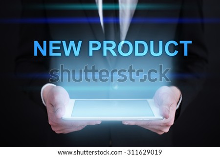 Businessman holding a tablet pc with "New product" text on virtual screen. Internet concept. Business concept. 