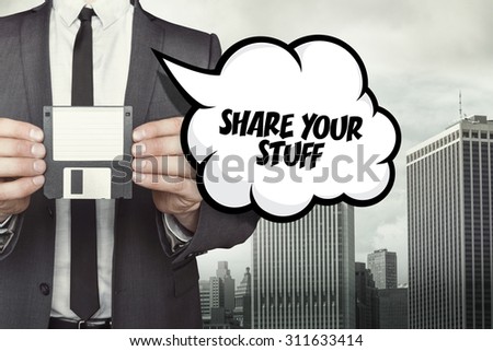 Share your stuff text on speech bubble with businessman holding diskette on cityscape background