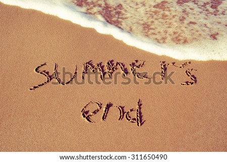 the text summers end written in the sand of a beach