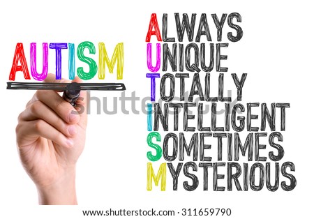 Hand with marker writing the word Autism
