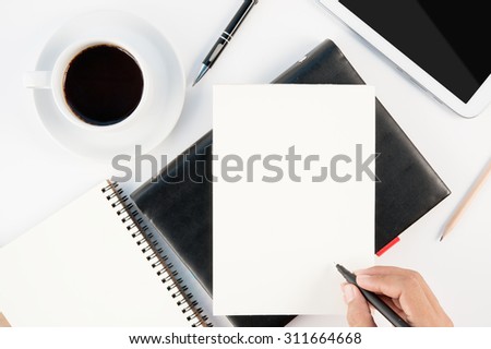 Cup of hot coffee tablet phone and man hand writing notebook on  white background .copy space