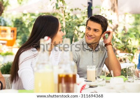 Portrait of a happy couple sitting in outdoor restaurant
