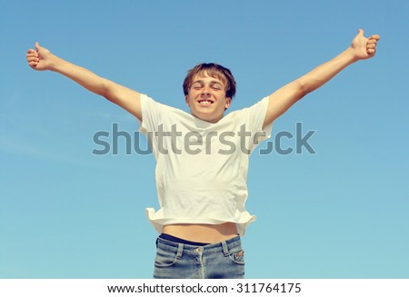 Toned Photo of Successful Teenager on the Blue Sky Background