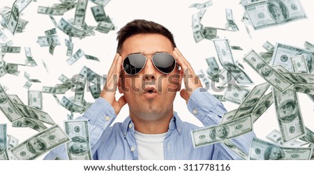business, finance, luck, fortune and people concept - face of scared or surprised middle aged latin man in sunglasses with heap of falling dollar money