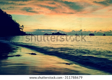 Vintage stylized photo add texture, Colourful of morning sky before sunrise on the beach at Honeymoon Bay on Ko Miang island in Mu Koh Similan National Park, Phang Nga Province, Thailand