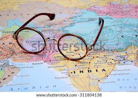 Glasses on a map of Asia - Delhi 