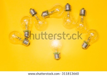 light bulb on yellow background. symbol ideas