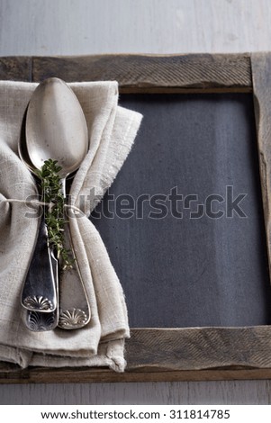 Tablespoons with a napkin and sprigs of thyme