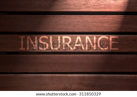 insurance text on wooden