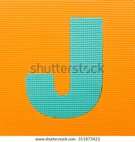 letter "J" on orange  background