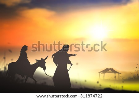 Nativity scene of bible stories concept: Silhouette Mary and Joseph journeying through the dessert with a donkey on sunset looking for a place to stay