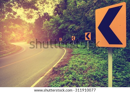 Shady beautiful curved road with cool, sunshine and the sign of hope on vintage style. Focus on the sign.
