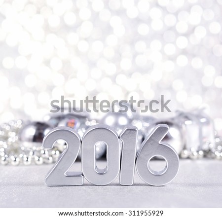 2016 year silver figures on the background of silvery Christmas decorations