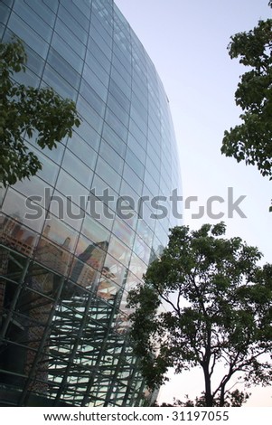 Glass on modern building with city skyline reflection