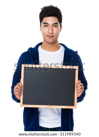 Young man show with the empty chalkboard