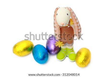 Toy rabbit hunter with Easter eggs