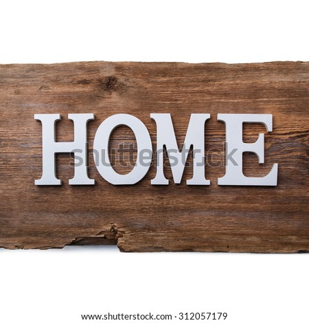 White letters with word HOME on wooden surface