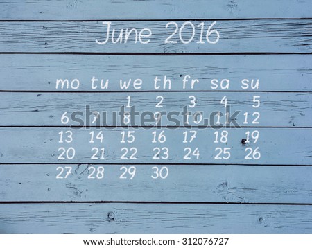 Calendar for June 2016 written with chalk on blue fence