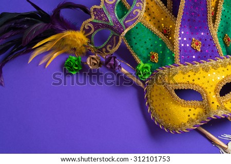 Mardi Gras or carnival mask on bright purple background