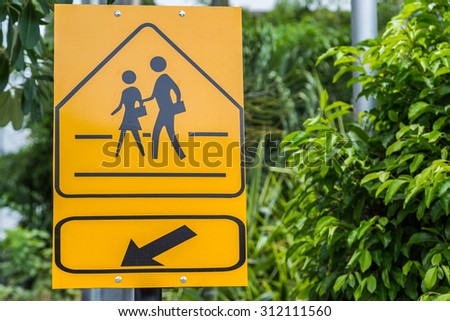 Traffic sign School warning sign here with green leaf background