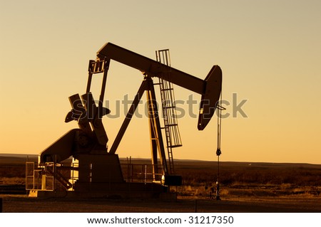 Working oil pump in rural Texas at sunset
