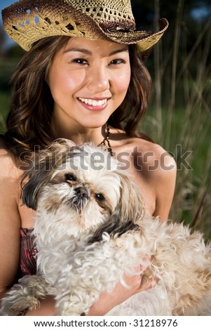 A beautiful girl with her dog outdoor during summer