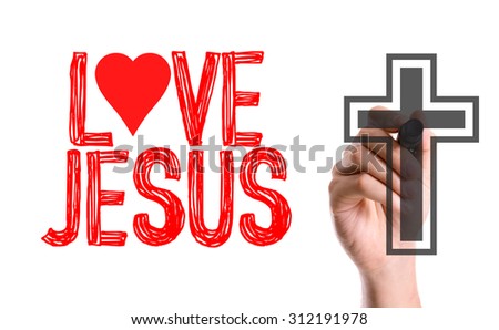 Hand with marker writing the word Love Jesus