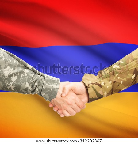 Soldiers shaking hands with flag on background - Armenia