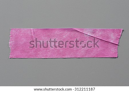 Pink Adhesive Tape on Grey Background with Real Shadow. Top View of  Masking Tape, Label or Paper Tag. Sticker Close Up with Copy Space for Text or Image