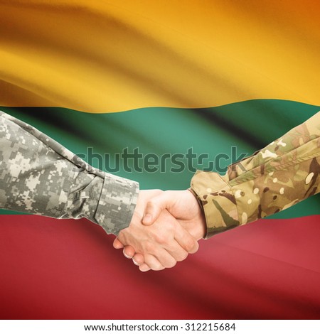 Soldiers shaking hands with flag on background - Lithuania