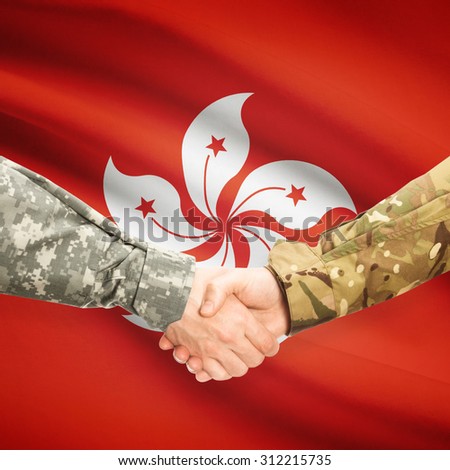 Soldiers shaking hands with flag on background - Hong Kong