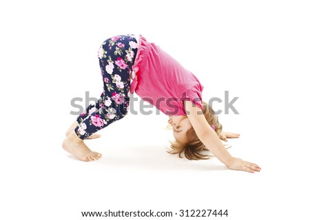 Little girl makes gymnastic exercise. Isolated on white background