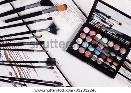 Natural brushes and palette eye shadow for professional makeup.