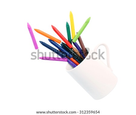 Colored candles with white cup isolated on white .