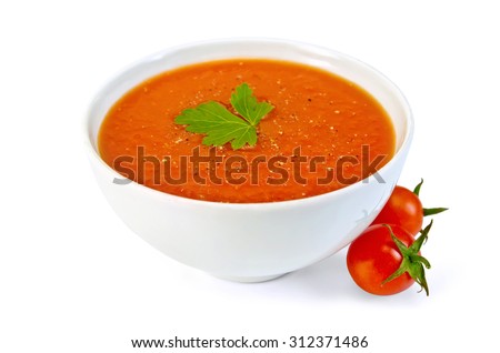 Tomato soup in a bowl with parsley and tomatoes isolated on white background Royalty-Free Stock Photo #312371486