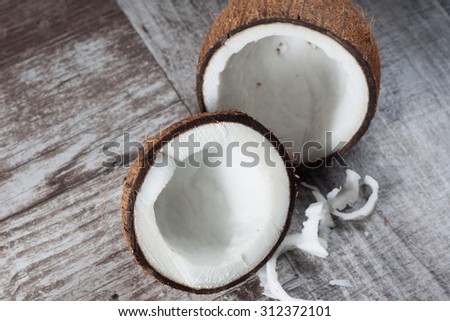 Ripe half cut coconut on a wooden backgroundRipe half cut coconut on a wooden background