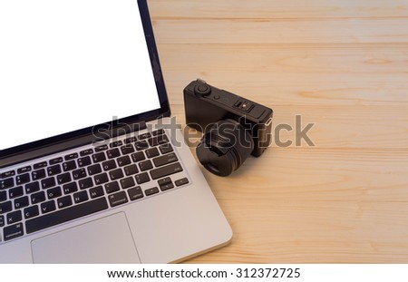 laptop with compact camera  on wood background