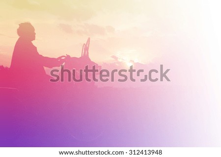 silhouette of grandmother cyclist on sunset sky