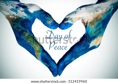 the hands of a young woman forming a heart patterned with a world map (furnished by NASA) and the text day of peace, slight vignette added