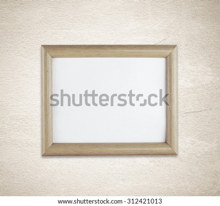 Blank wooden picture frame on grunge cement wall background, template